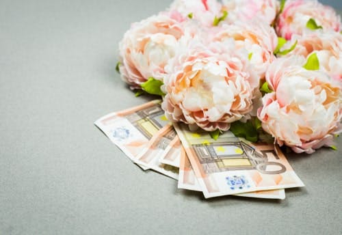 peonies sitting on top of €50 banknotes