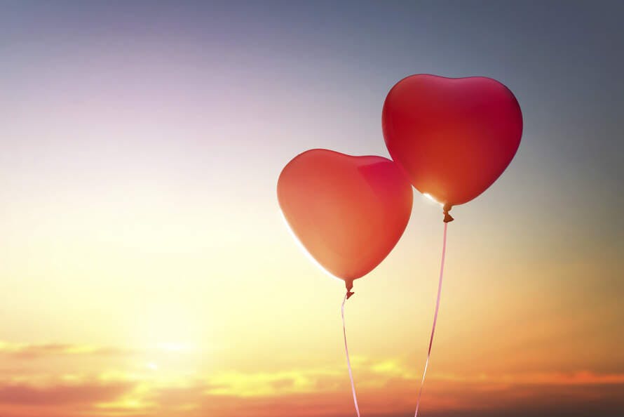 red balloons in the shape of hearts