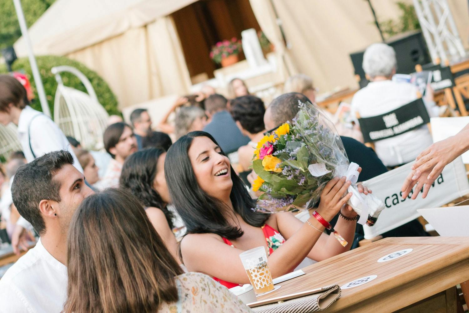 Happy woman receiving FloraQueen flowers