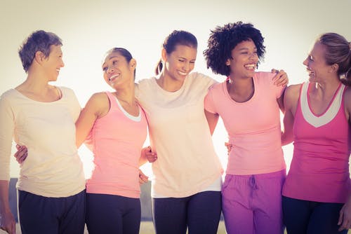 Women holding hands laughing together