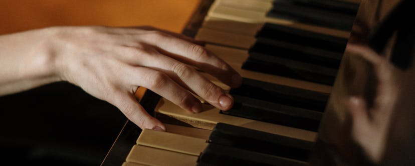 Woman hand on the piano