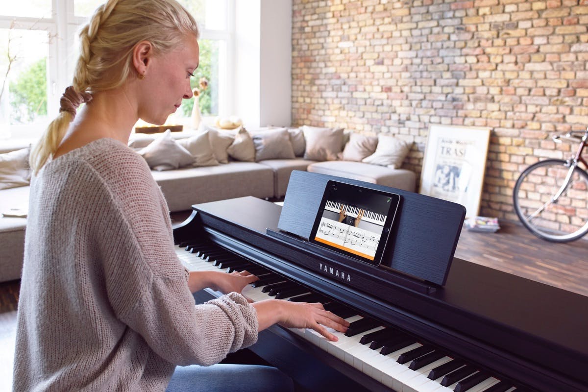 Blonde woman playing piano with an app
