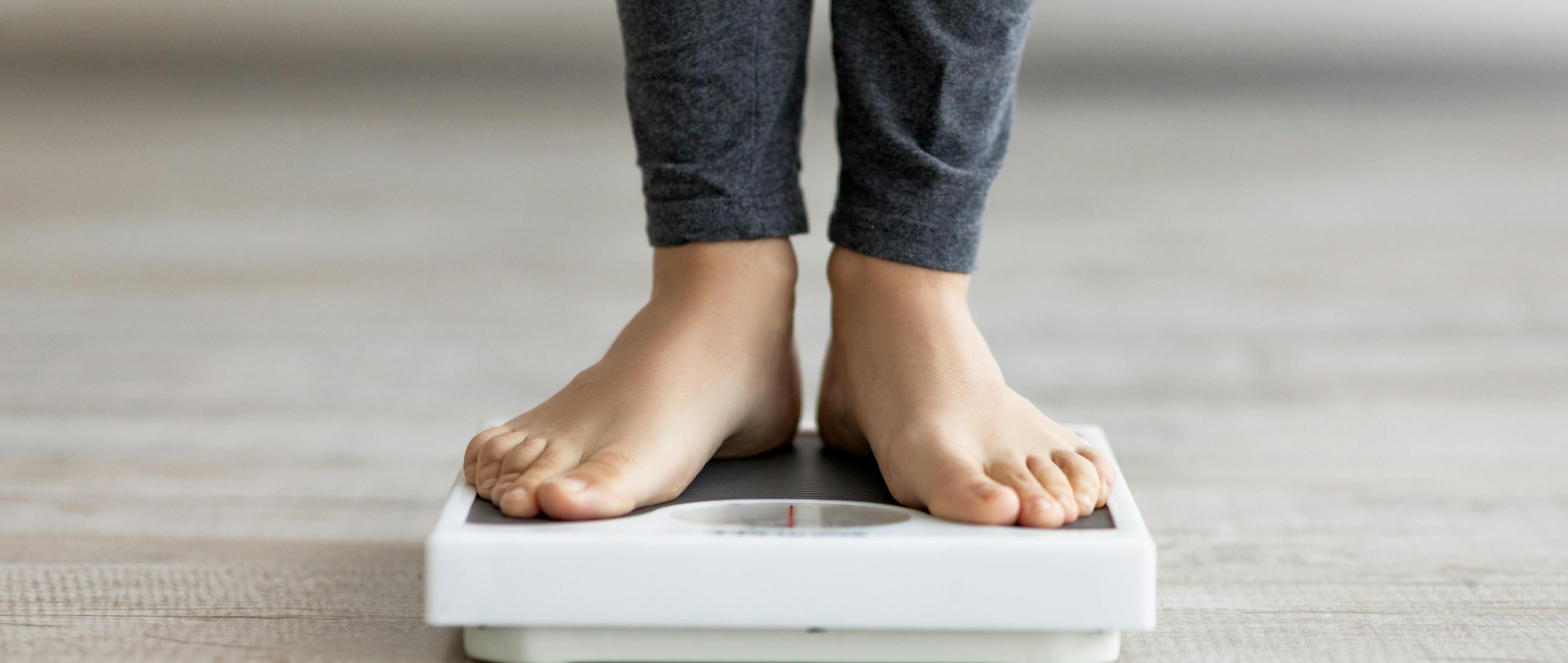 Indian woman standing on scales