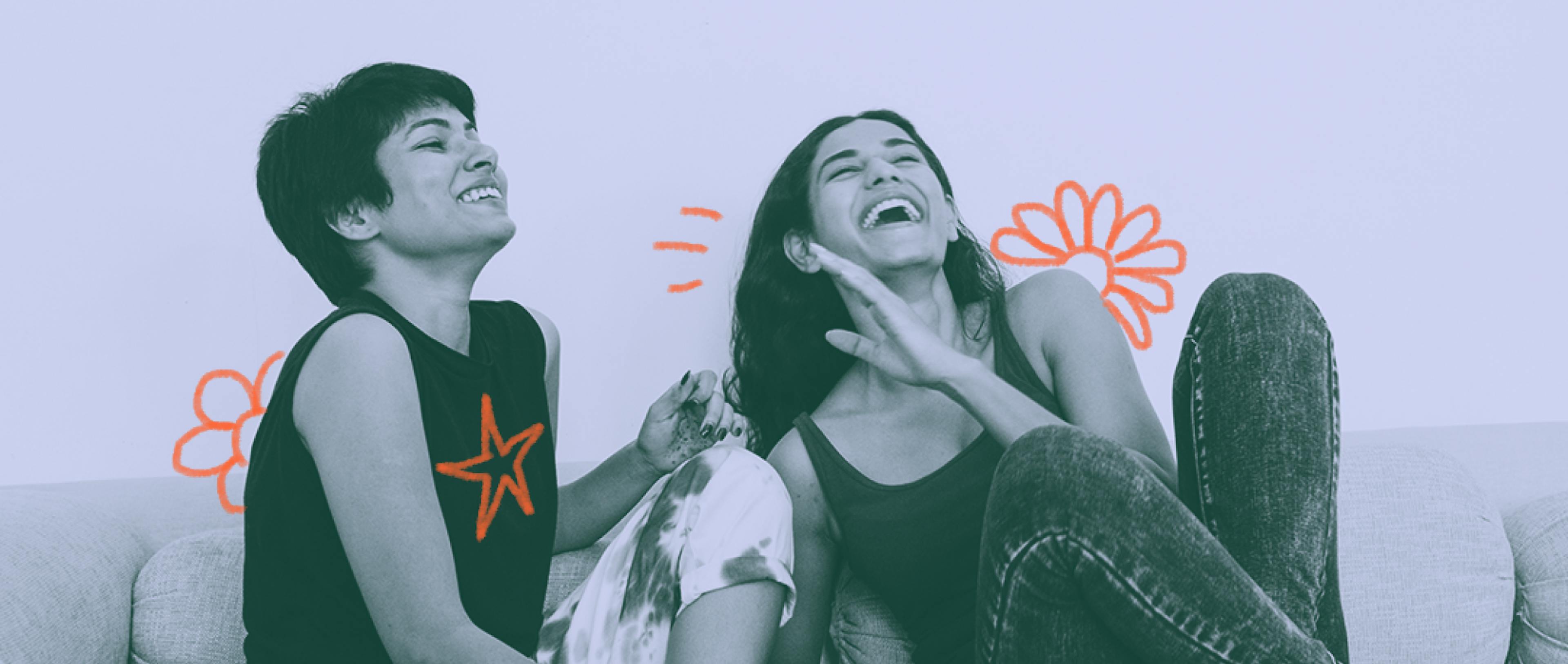 Two girls sitting together, laughing and having a good time