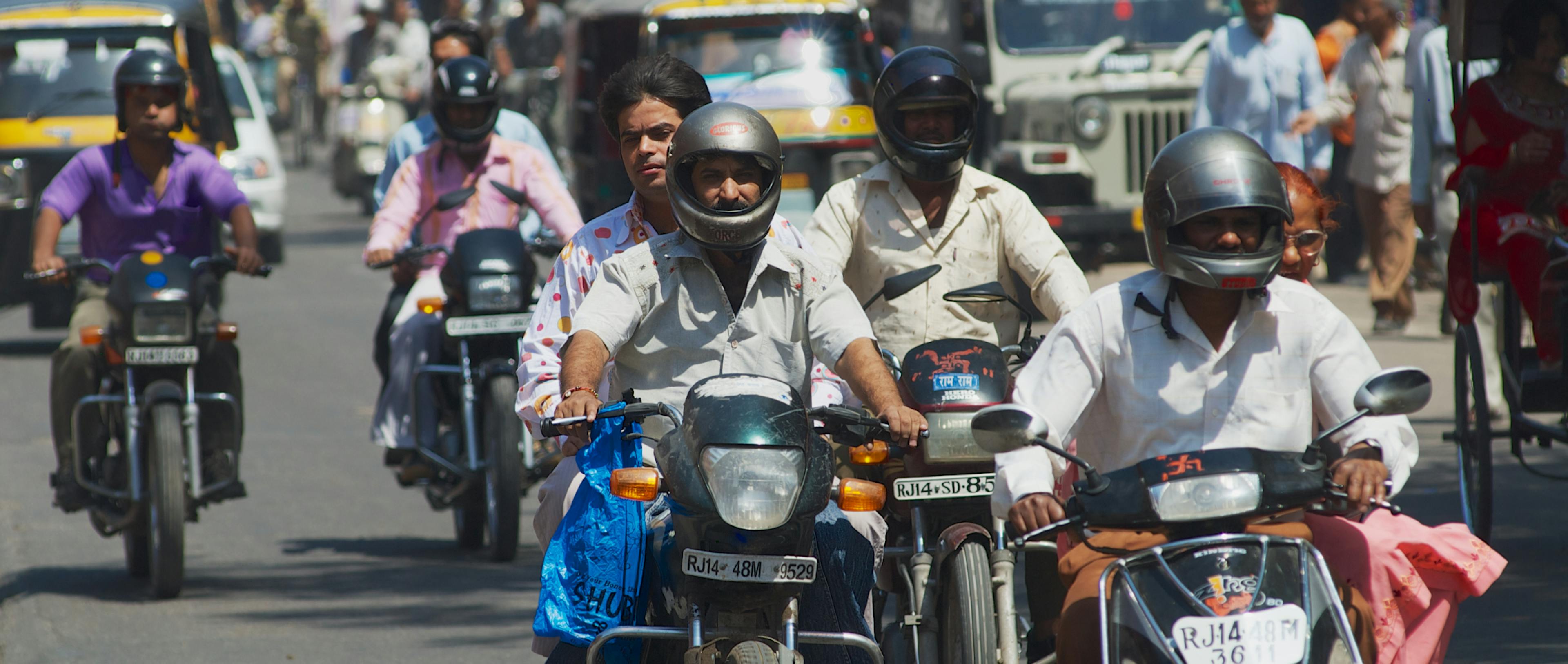 People riding a two-wheeler on the road