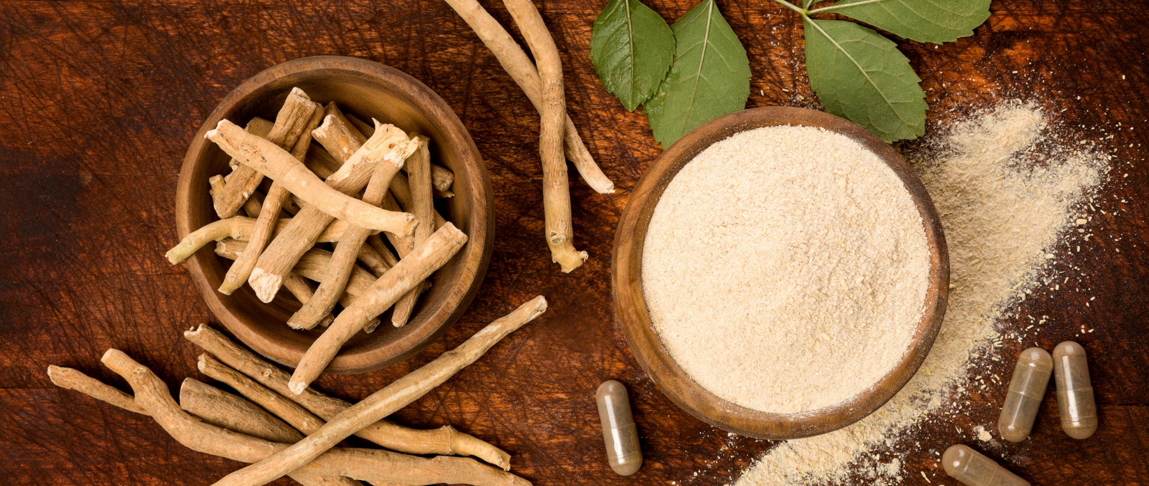 Ashwagandha superfood powder and root on cutting board on wooden table.