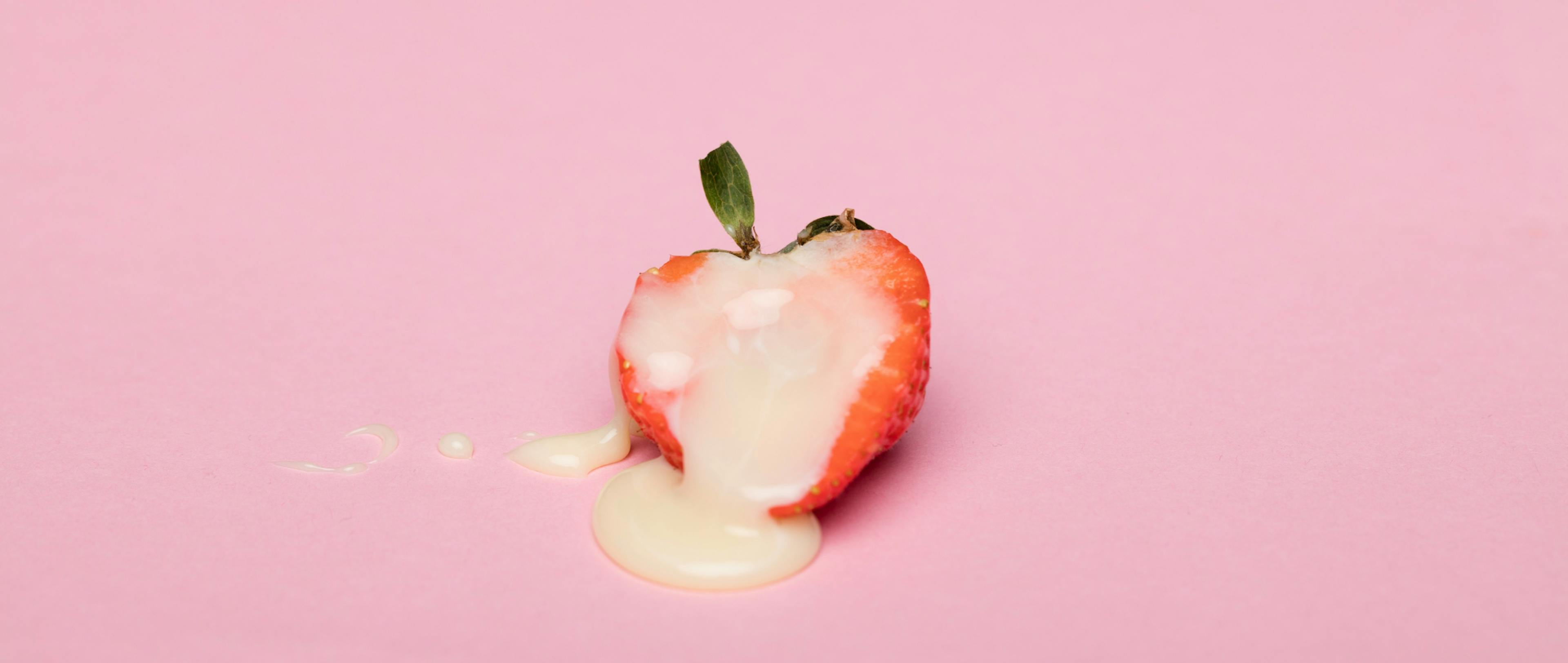 Red cherry fruit on pink surface