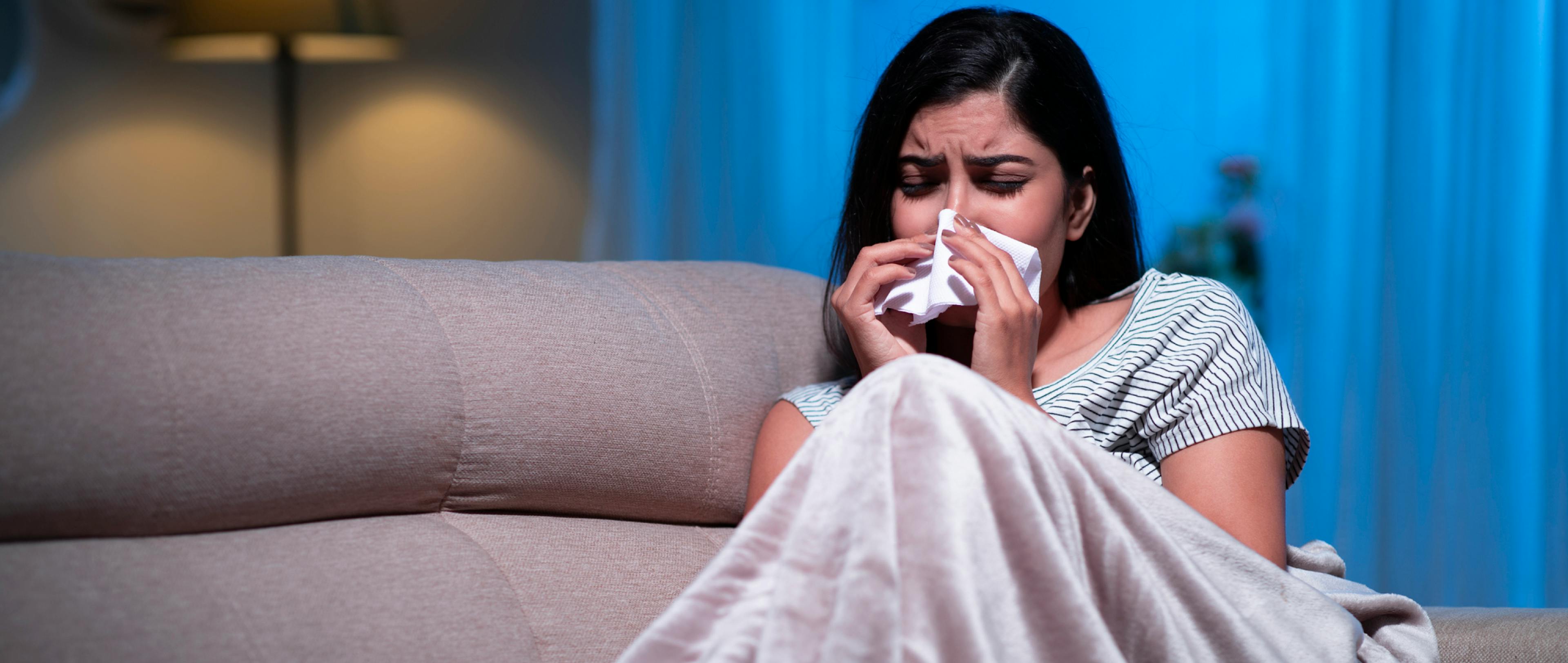 Young South Asian woman suffering from cold or flu.