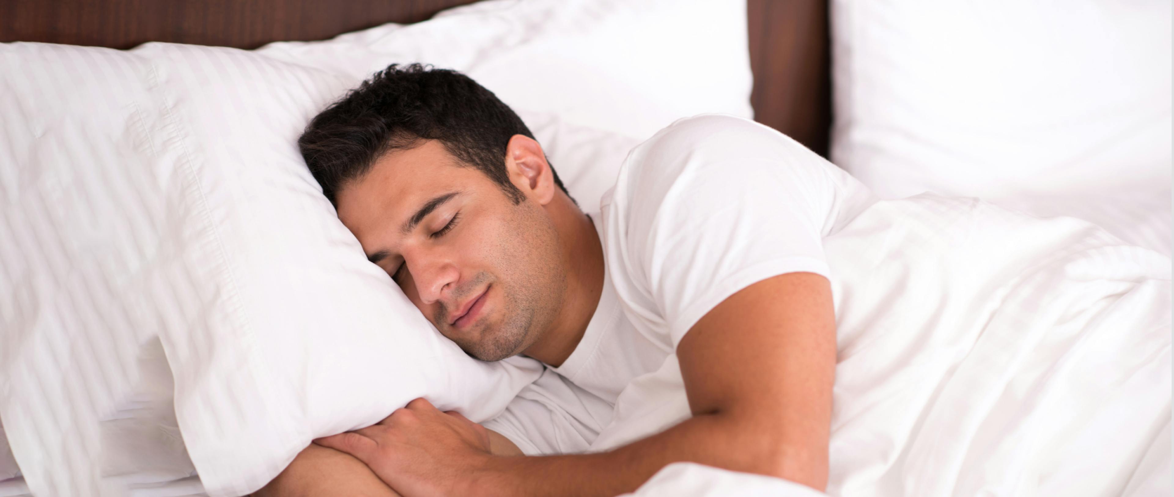 A man sleeping in a comfortable bed