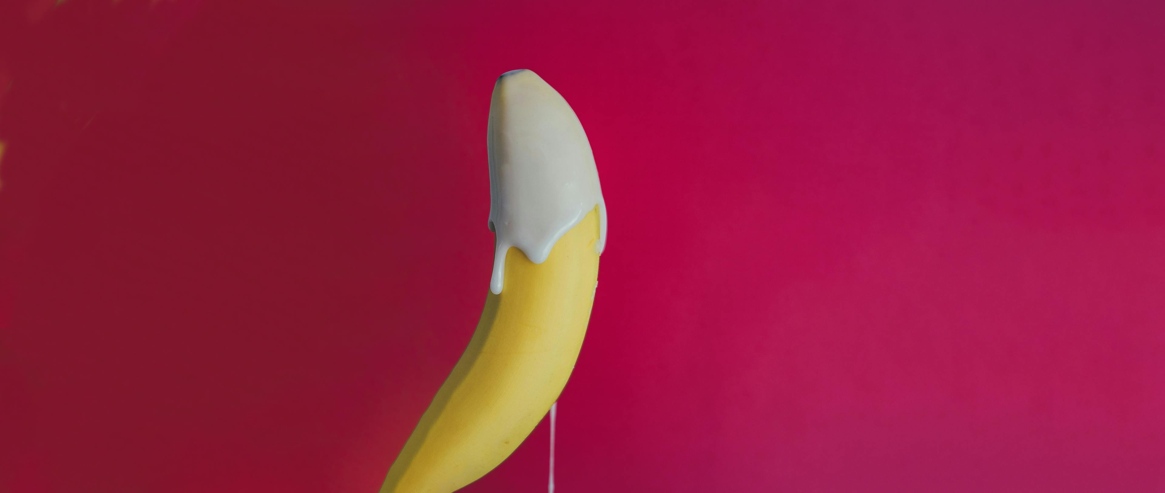 A yellow banana dipped in cream.