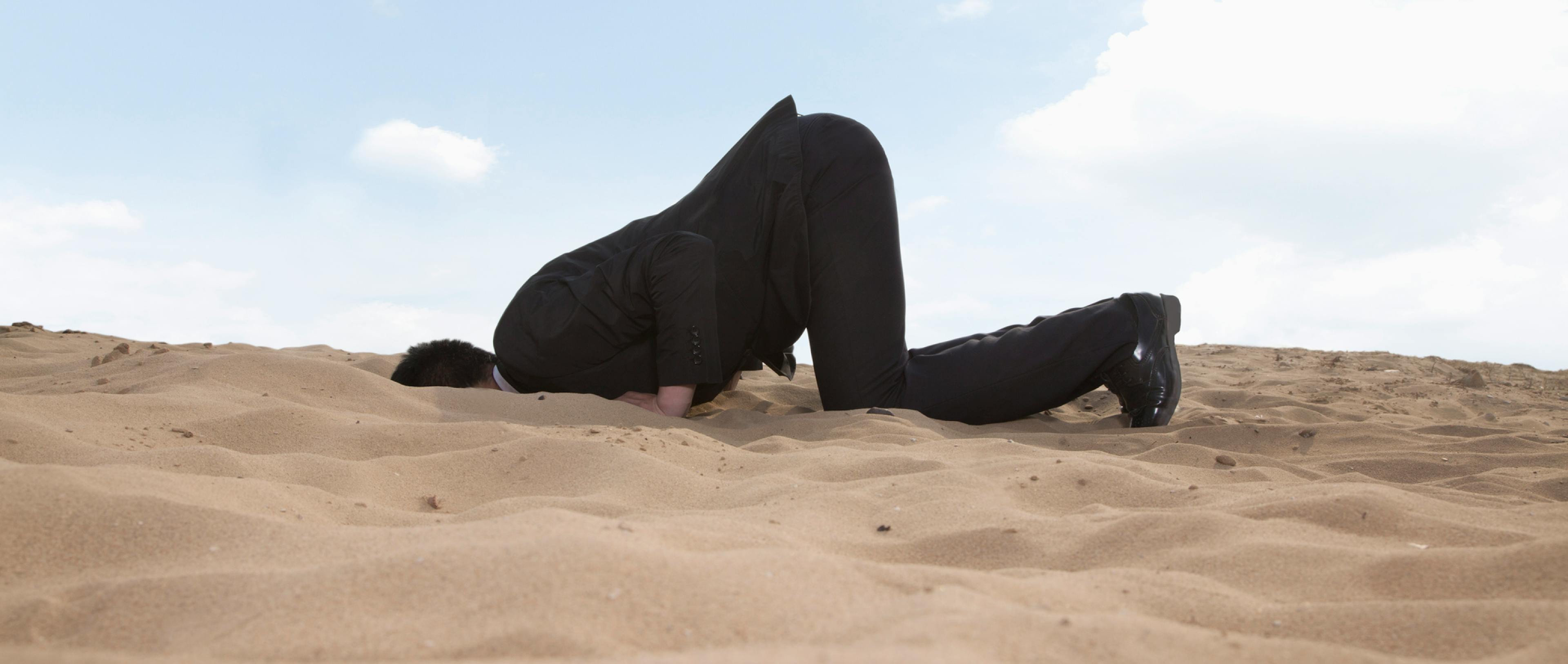 A man diving into the sand in a dessert