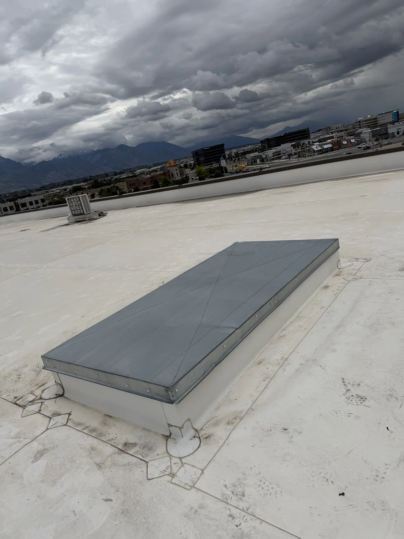 commercial flat roof installation with white membrane and skylight hatch on building - Boise, ID - Flux Boise Roofing & Siding