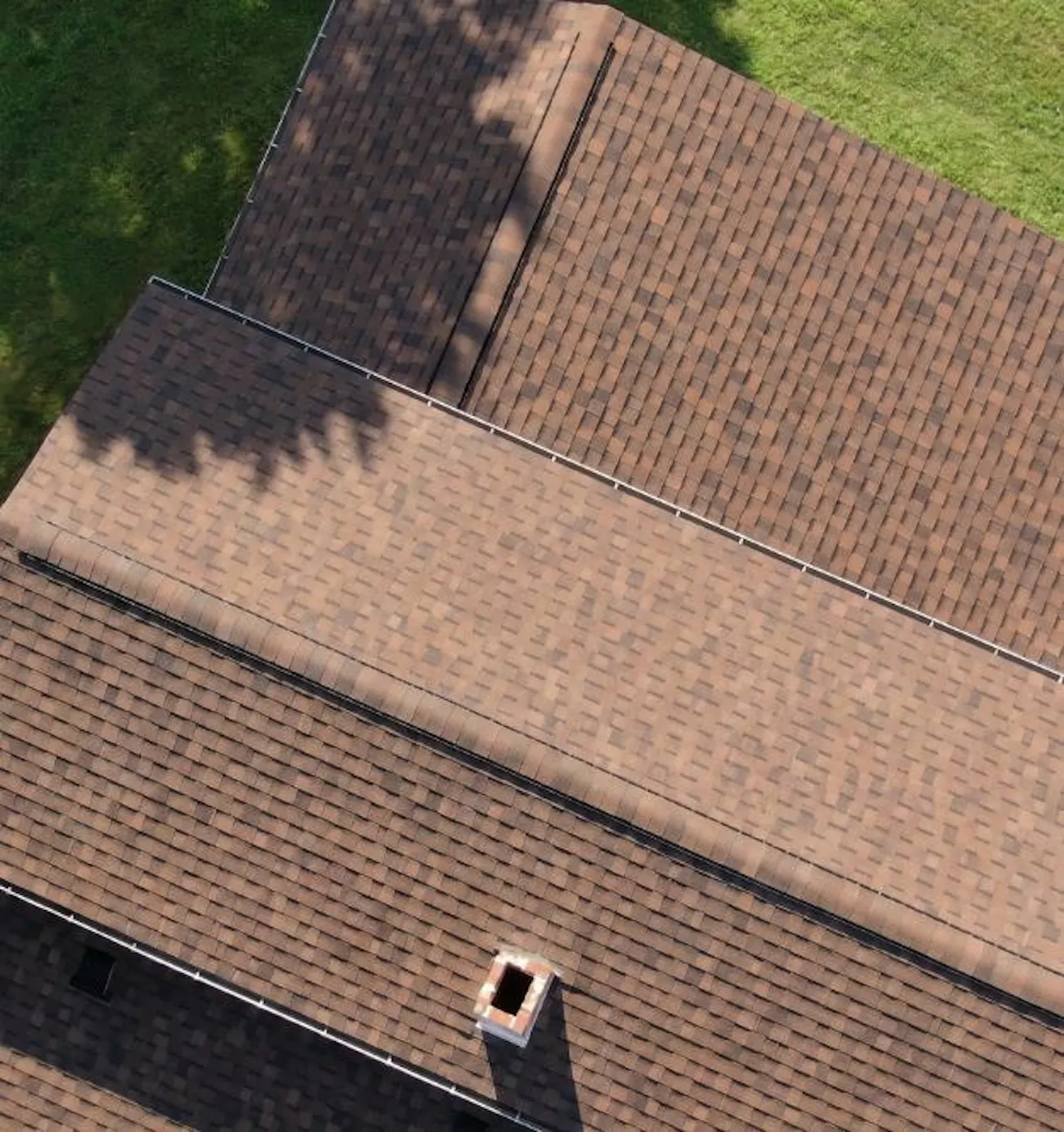 aerial residential roof replacement with brown architectural asphalt shingles and chimney - Boise, ID - Flux Boise Roofing & Siding