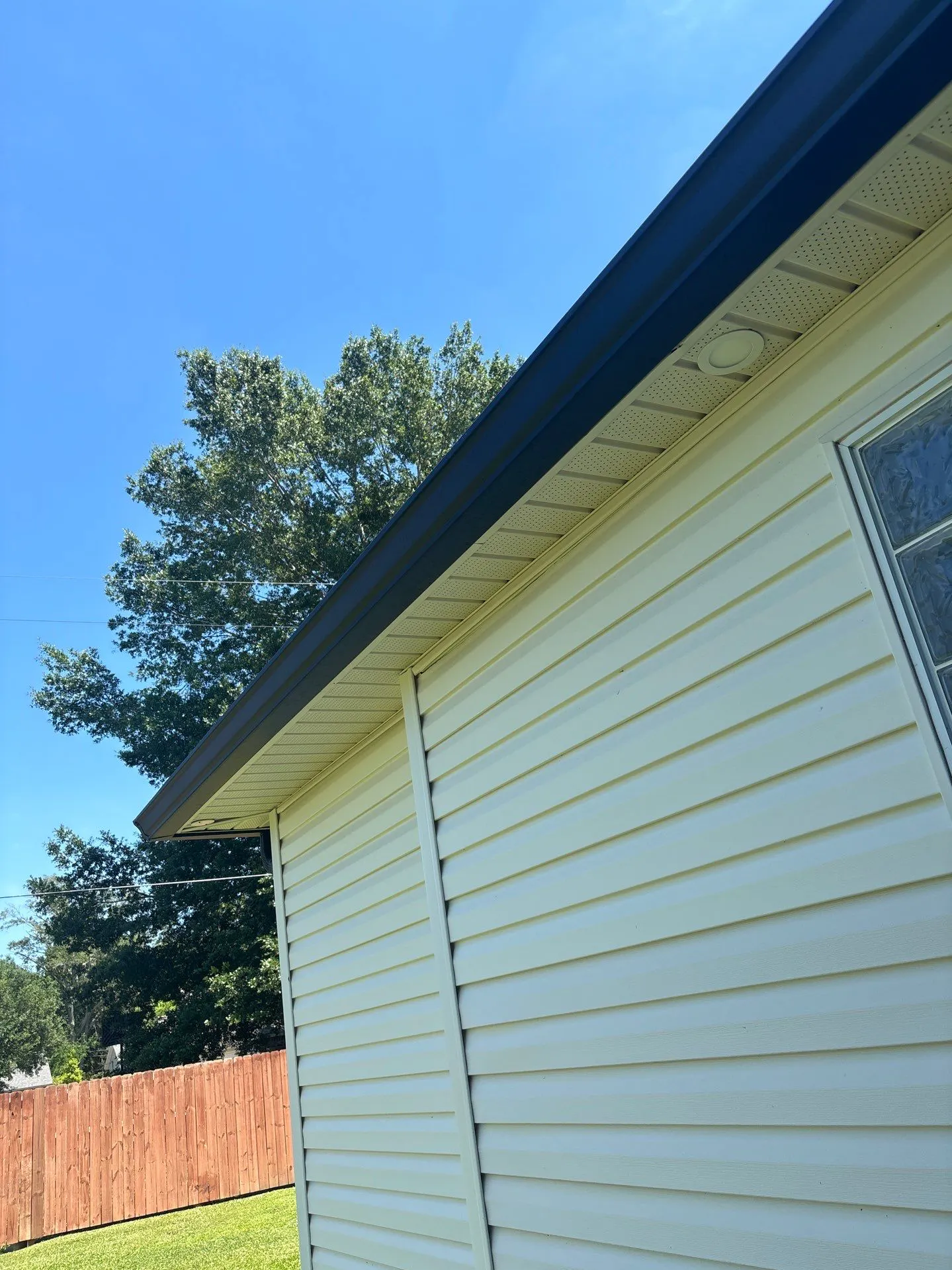 professional vinyl siding installation with dark gutter system and vented soffit - Boise, ID - Flux Boise Roofing & Siding