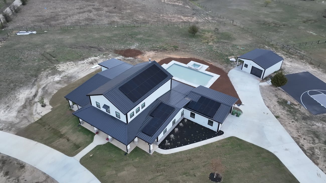 Drone view of metal roof with solar panels