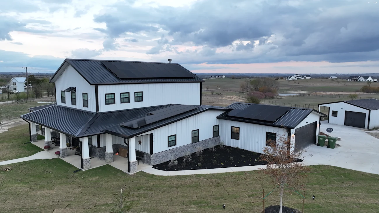 Metal roof exterior with three sections of solar panels