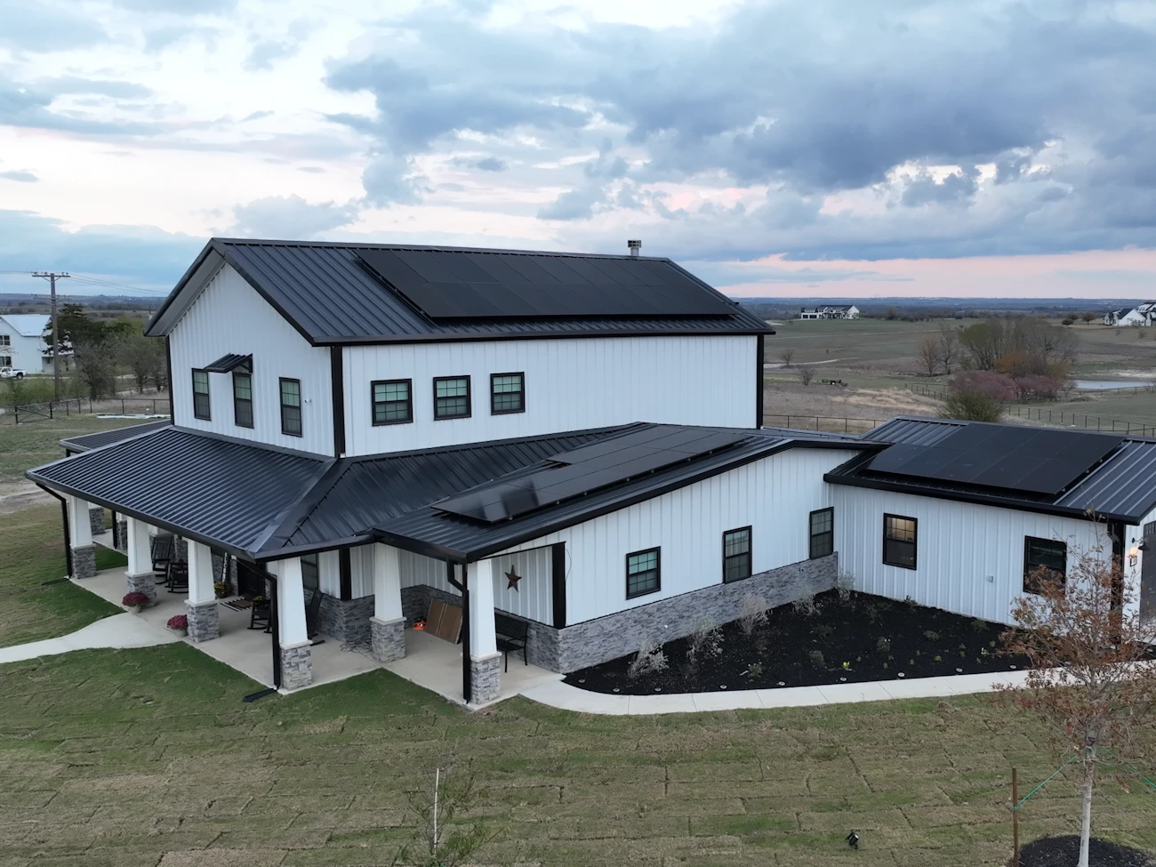 Metal roof exterior with three sections of solar panels