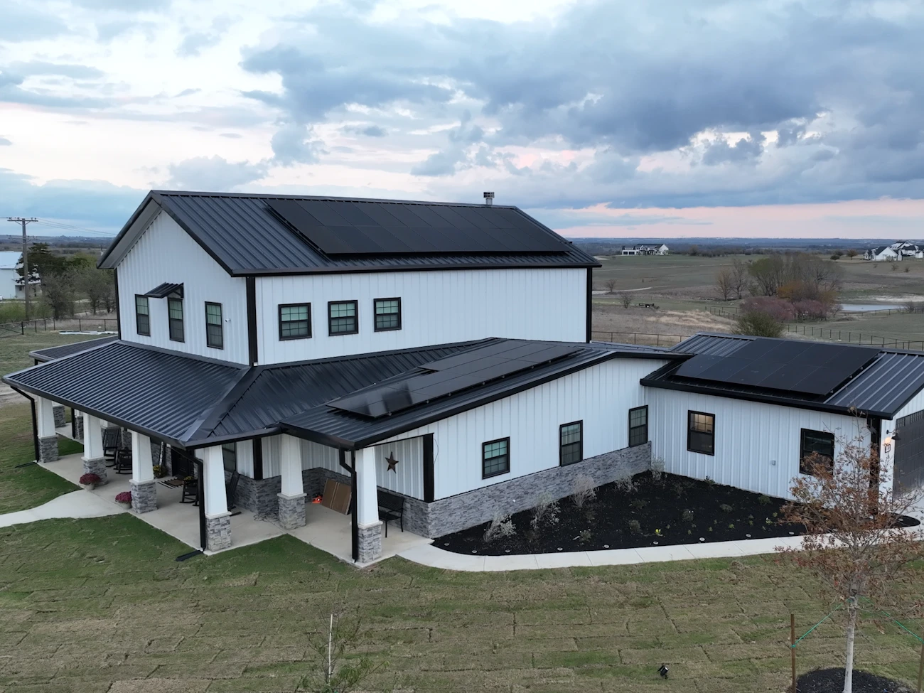 Metal roof exterior with three sections of solar panels