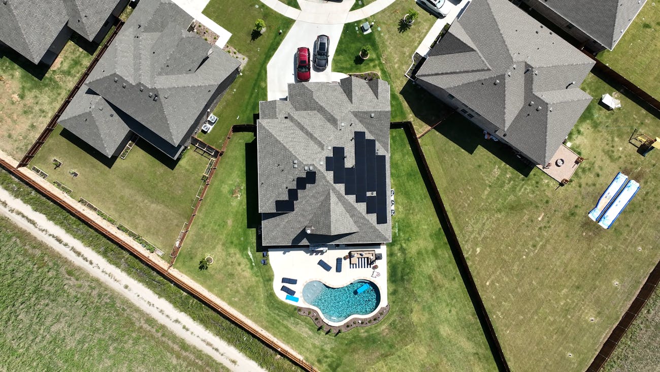Aerial roof view of home with solar panels and roof install