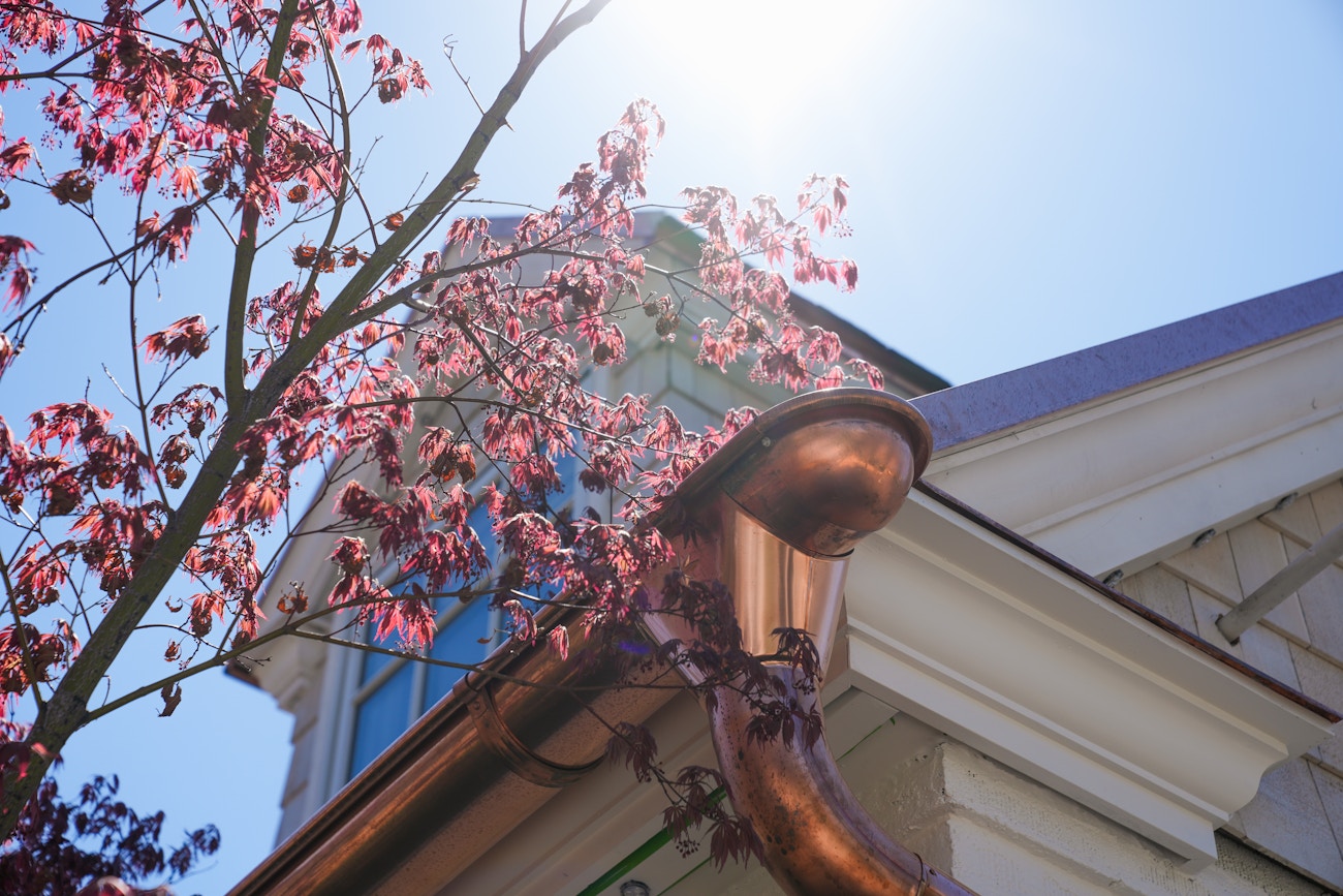 Gutter end with downspout