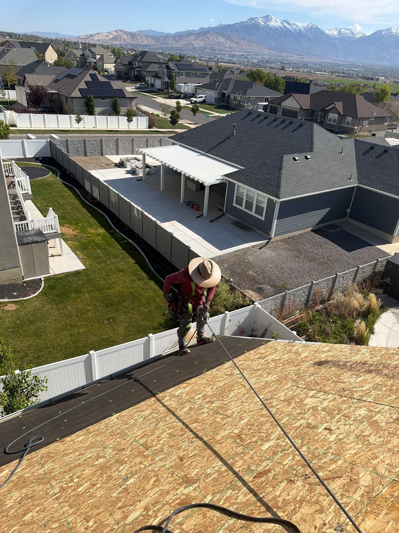 Copy of roofing contractor with safety harness performing roof replacement with underlayment installation - Boise, ID - Flux Boise Roofing & Siding