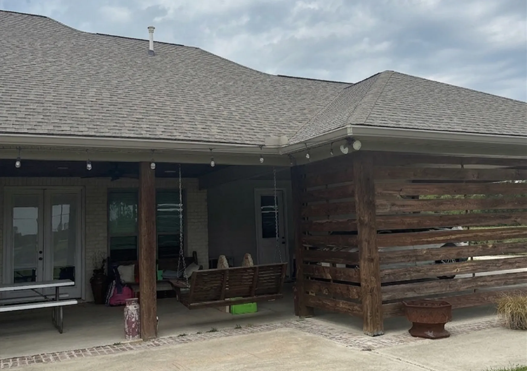 residential asphalt shingle roofing with seamless gutter installation and covered patio - Boise, ID - Flux Boise Roofing & Siding