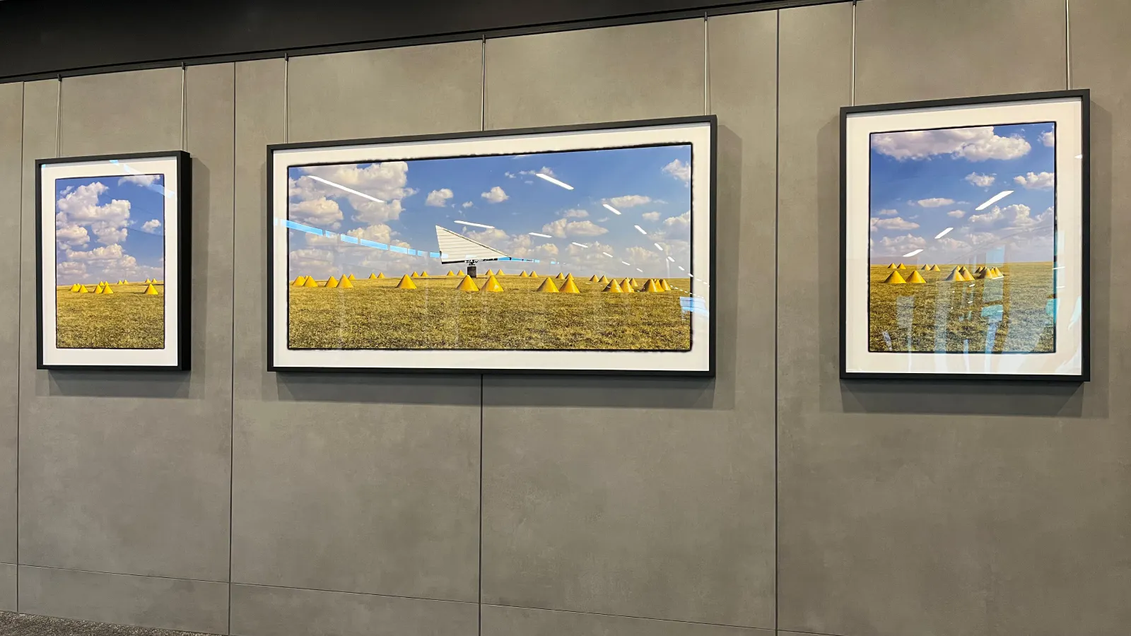 An artistic triptych portrait of a pyramid-shaped wind direction indicator placed near runways to guide aircraft takeoffs and landings.