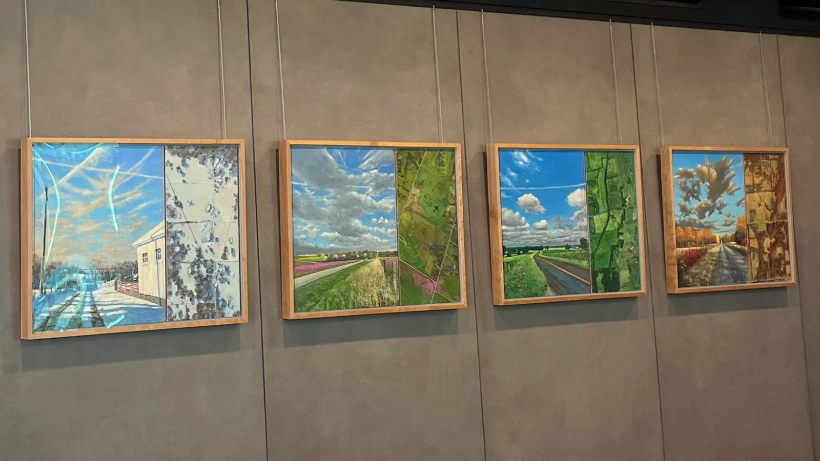Four landscape paintings depicting seasonal changes hang on the wall at gate B60 in Kansas City International Airport.