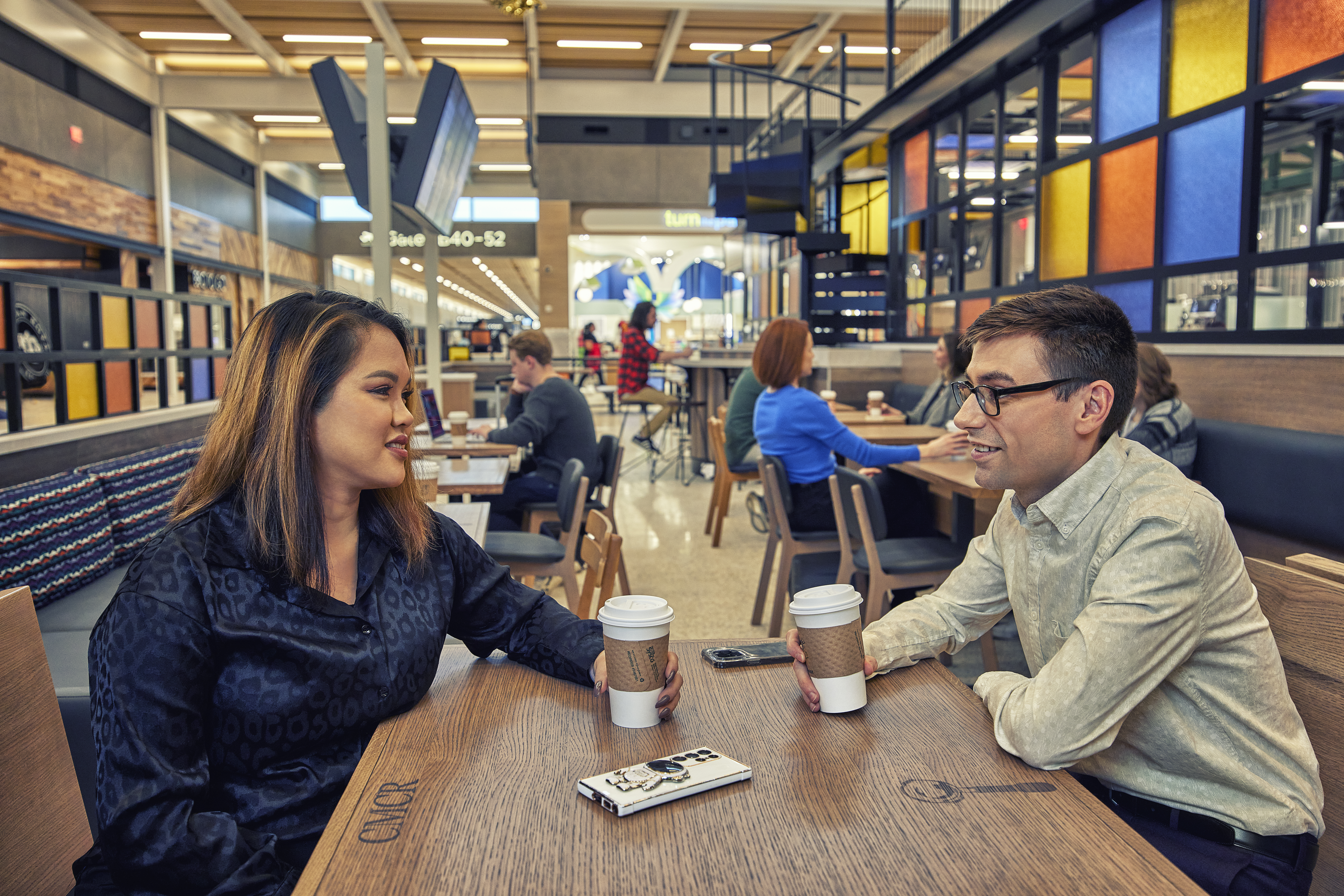 Travelers enjoying coffee at the airport
