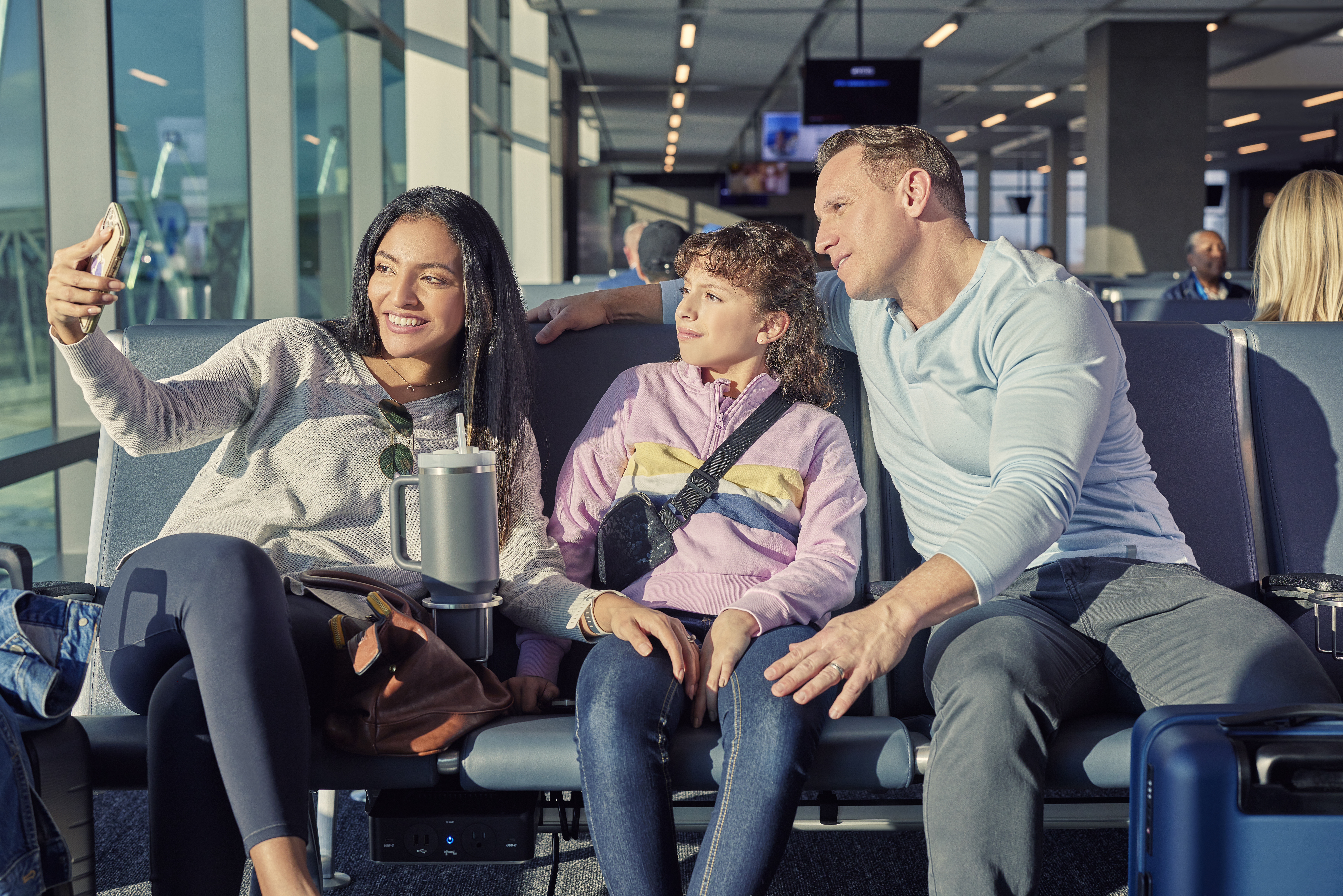 Travelers waiting at a gate at the airport