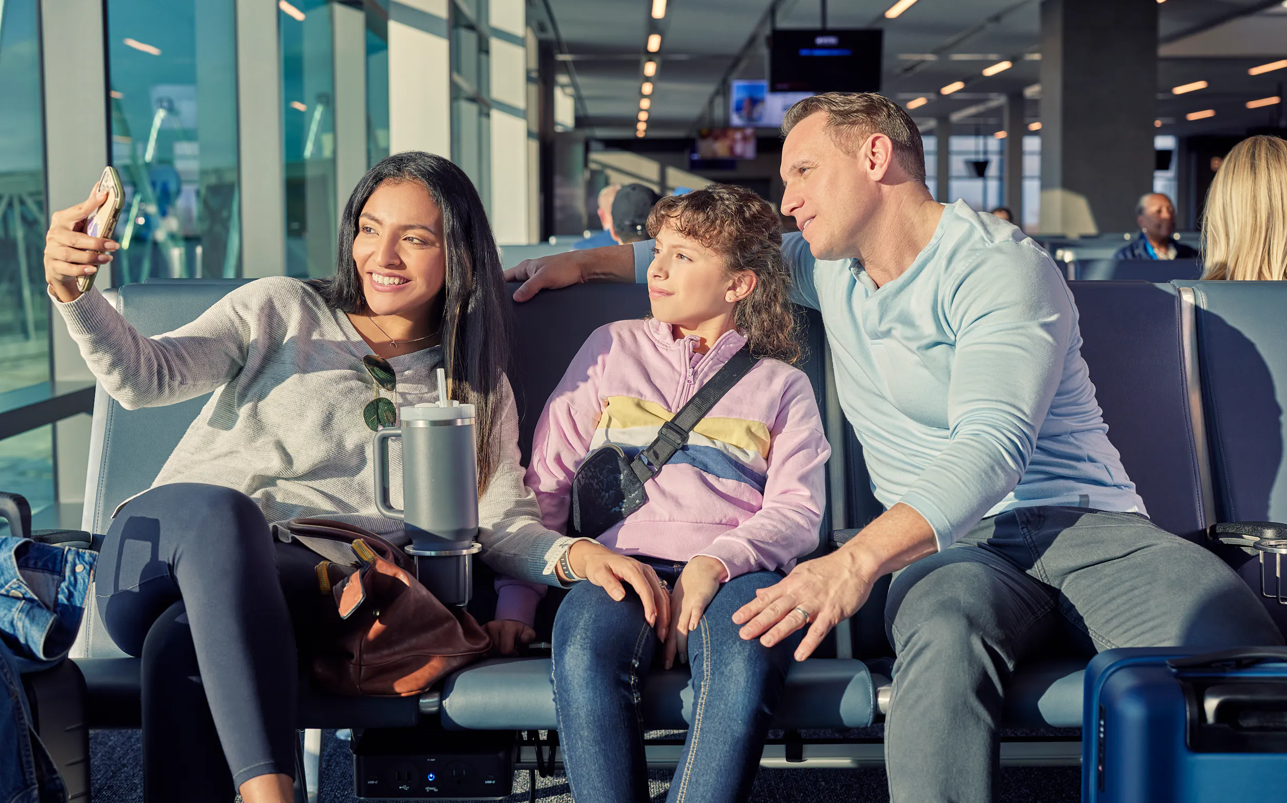 Travelers waiting at a gate at the airport
