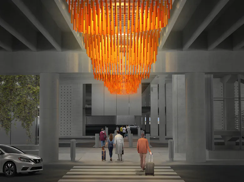Artists rendering of travelers walking beneath a massive, suspended orange sculpture made of vertically hanging rods, forming a glowing chandelier-like canopy under an airport overpass.
