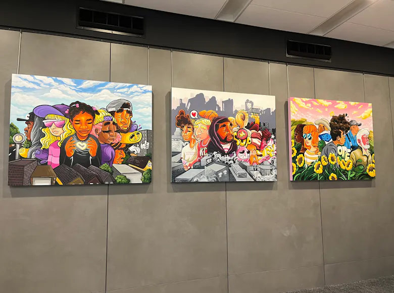 Triptych of colorful, cartoon-style paintings depicting diverse groups of people in urban and natural Kansas City scenes, with elements like rooftops, sunflowers, and city skylines in the background.