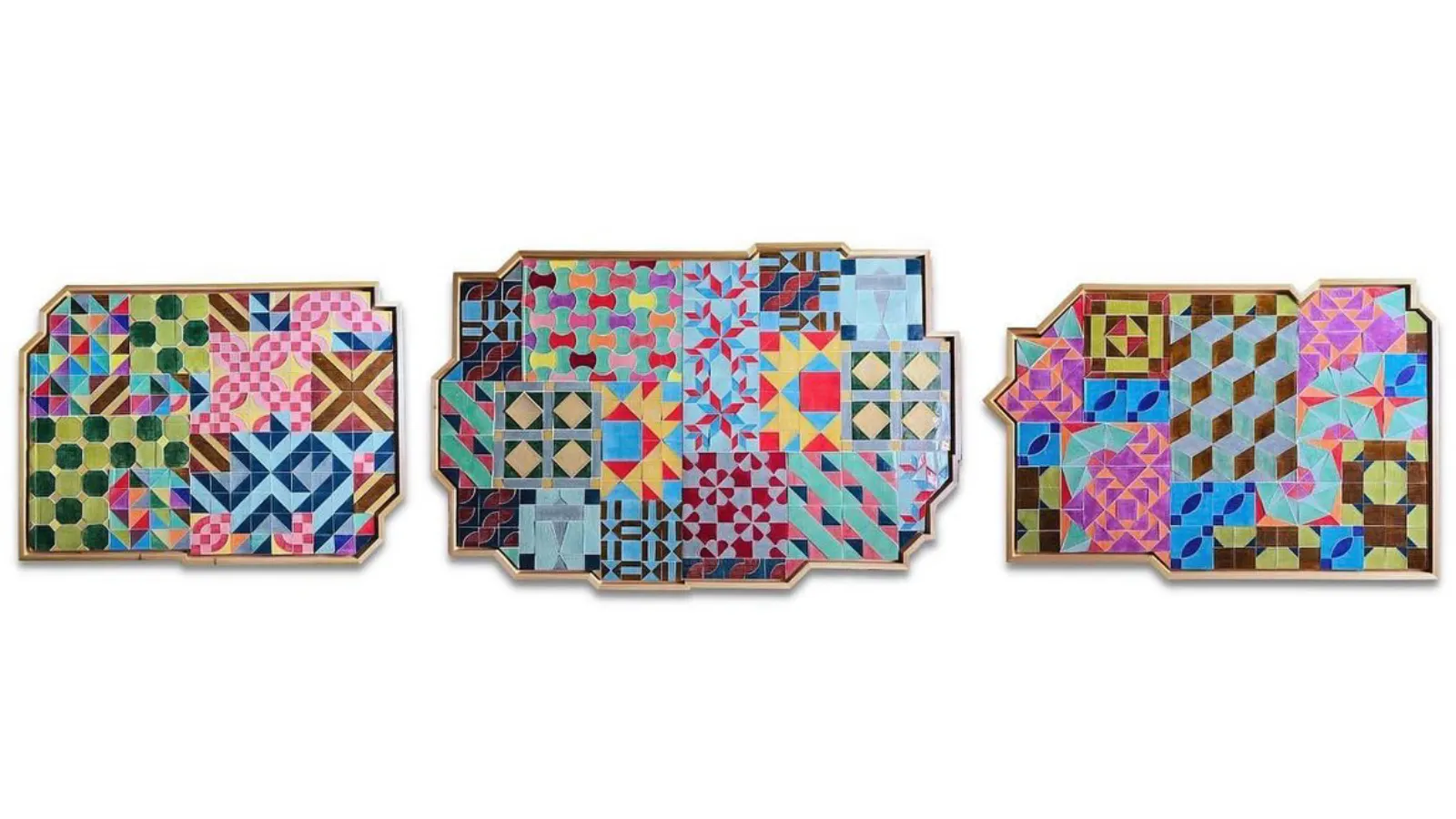 Three framed artworks featuring colorful quilt-like patterns in bold geometric shapes, arranged in intricate, asymmetrical wooden frames.