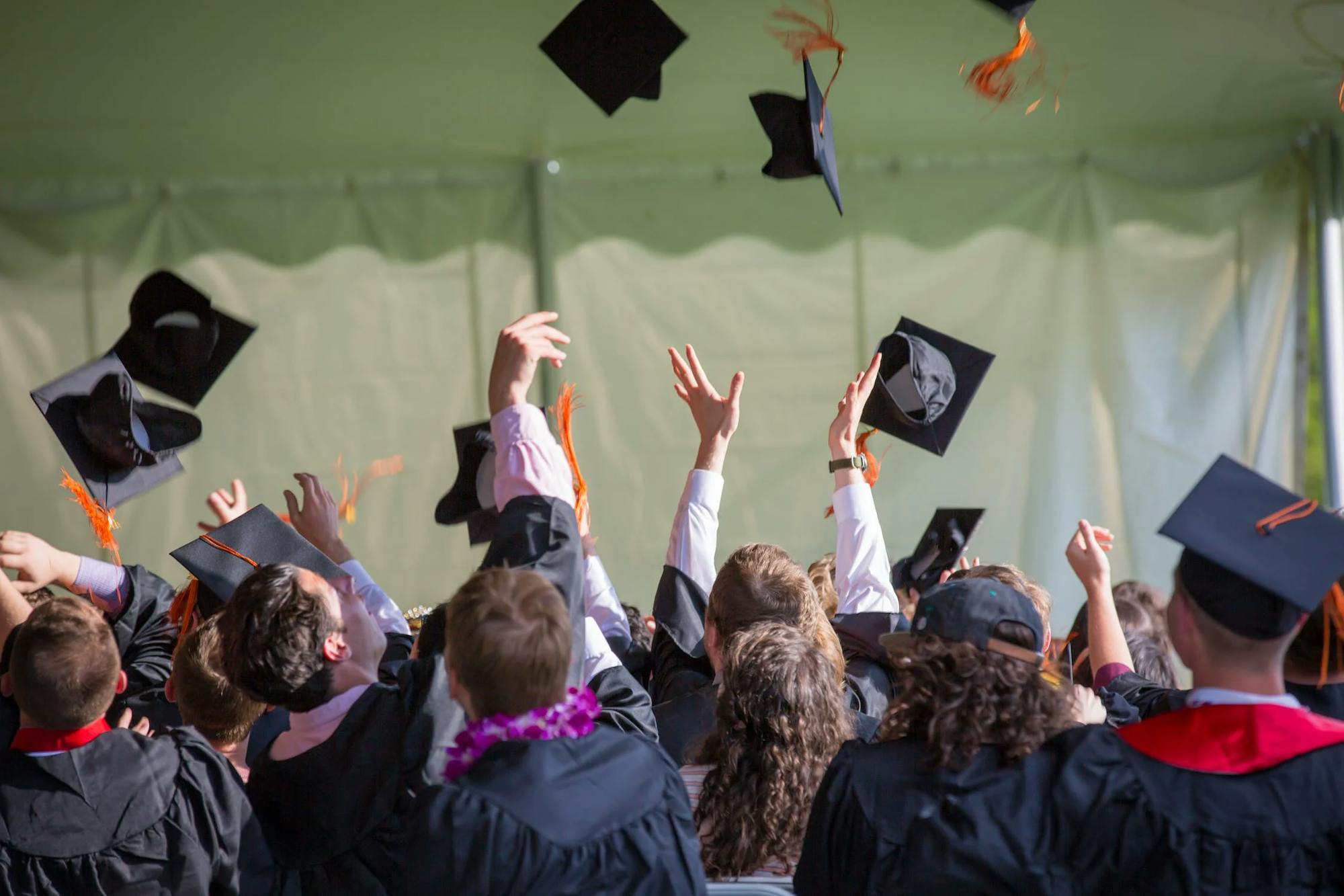 Graduation party: graduates throw their bachelor hats into the air 