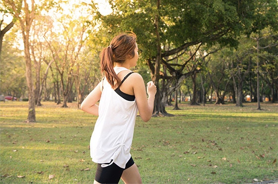 Woman running in the sunset.