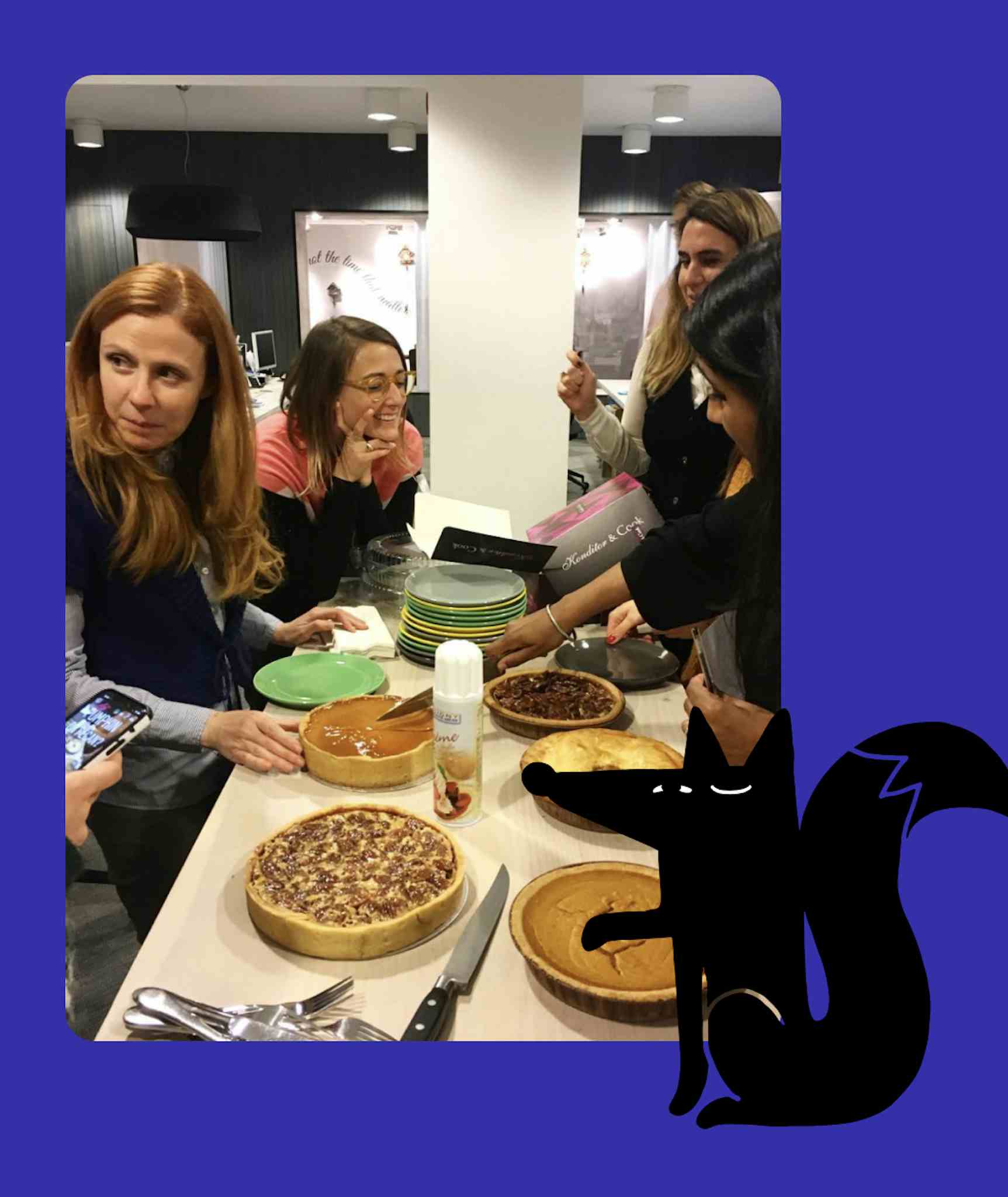 Fold7 staff at a table with cakes