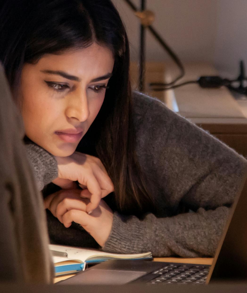 A woman staring at a computer