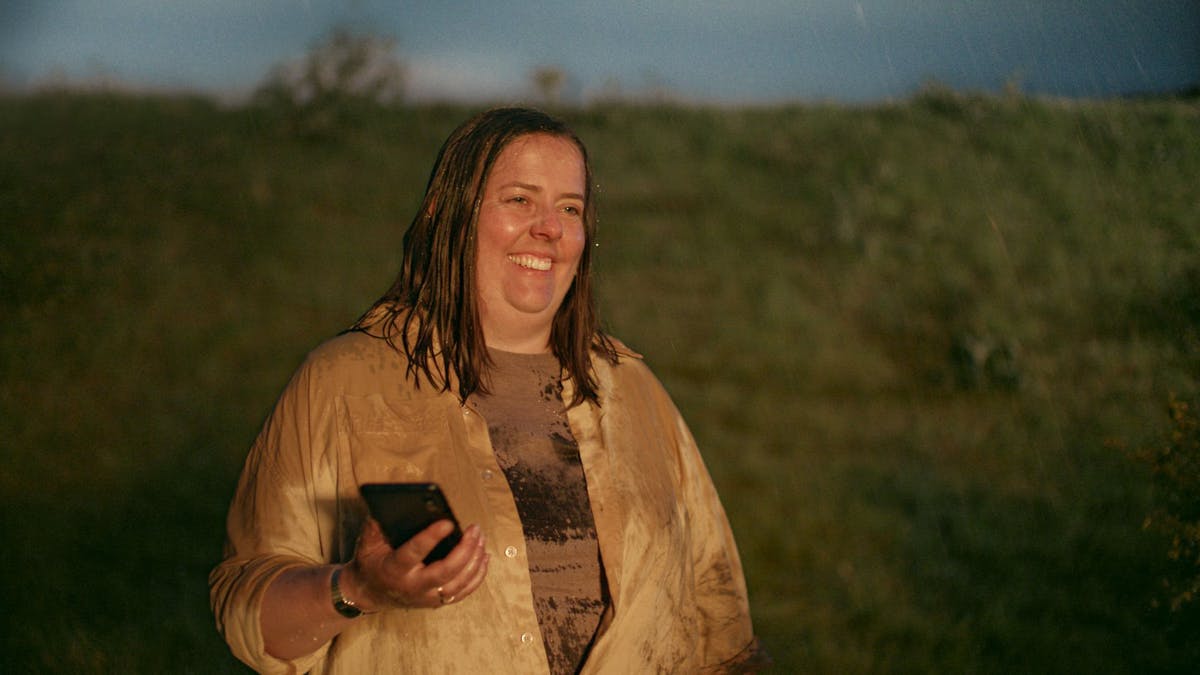 Smiling woman with a phone