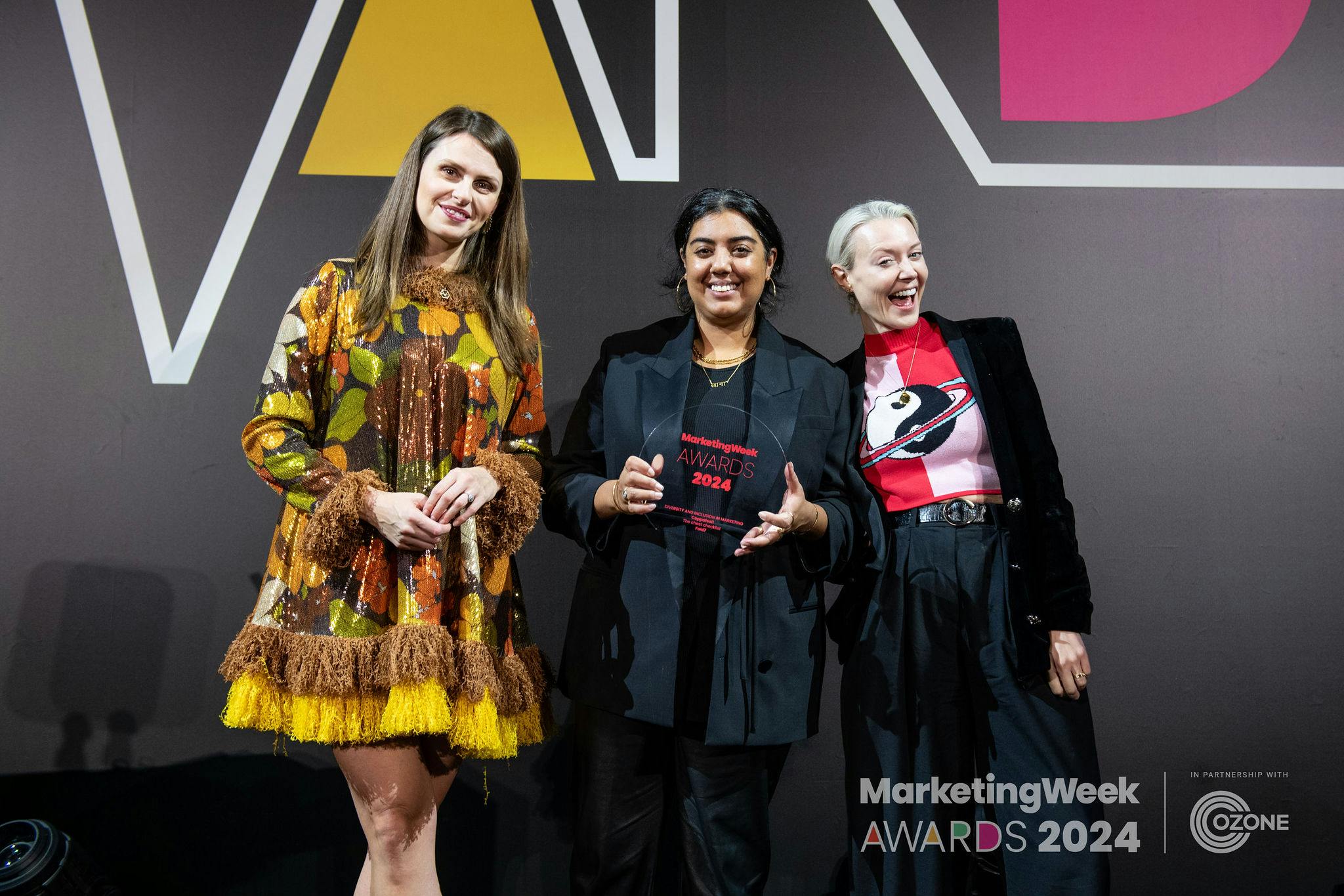 Fold7 employees holding a gold marketing weeek award 