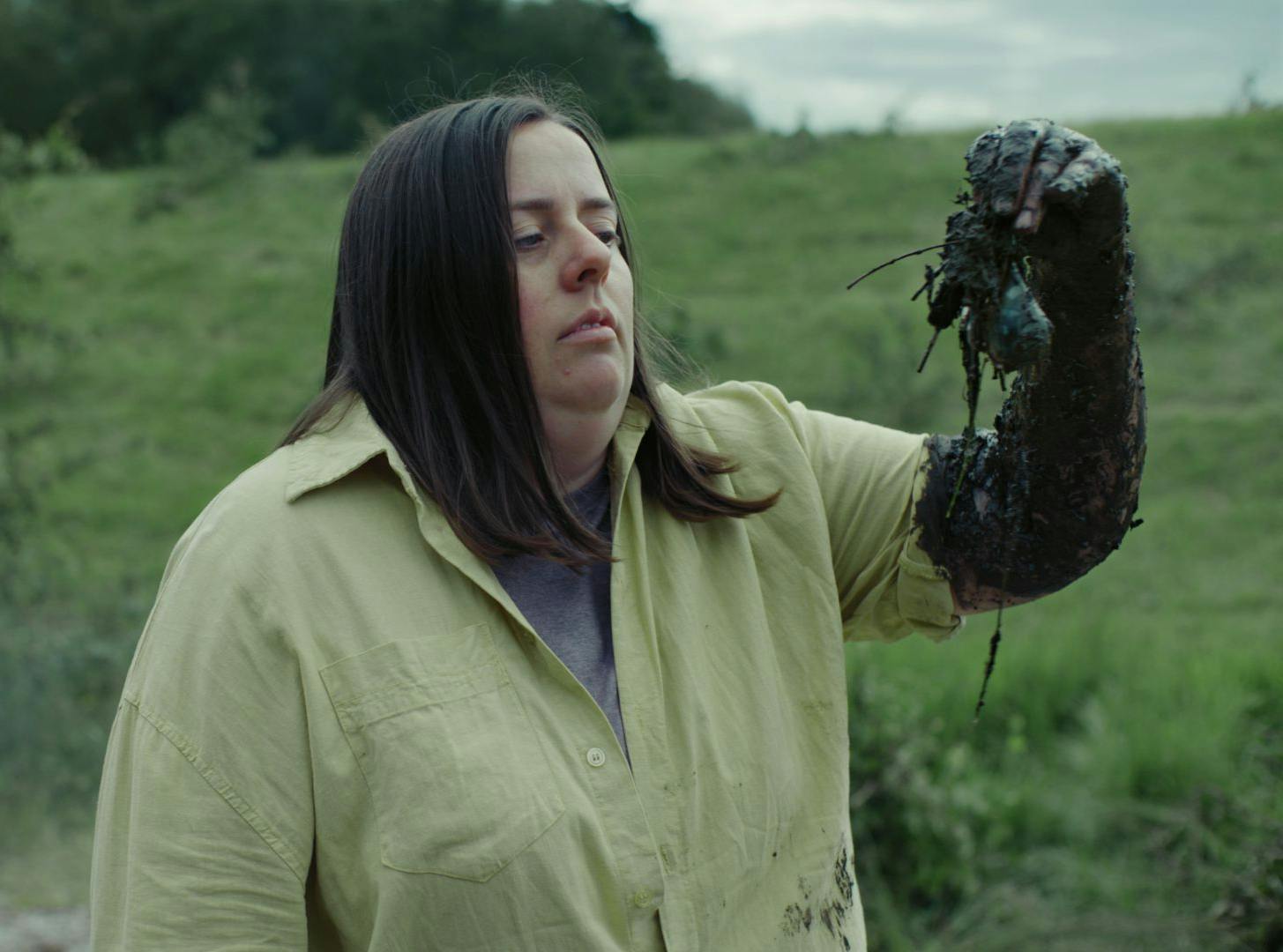 Dark comedy - photo of a lady holding muddy vegetables