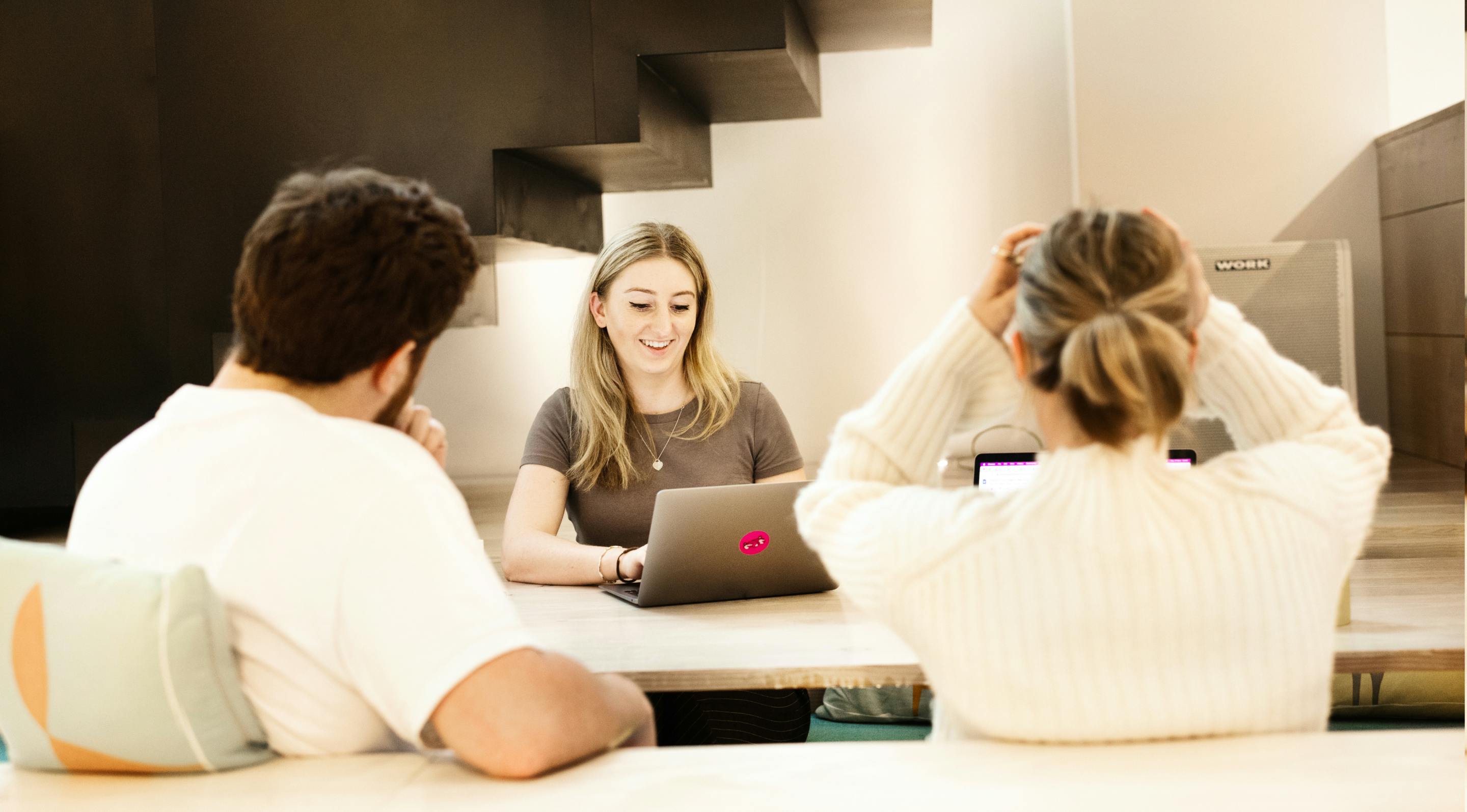 Fold7 employees at desk in meeting