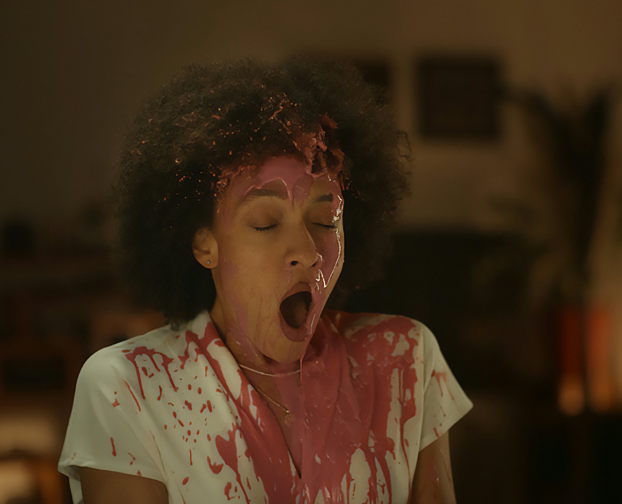 Woman in surprise with red paint splashed on t-shirt