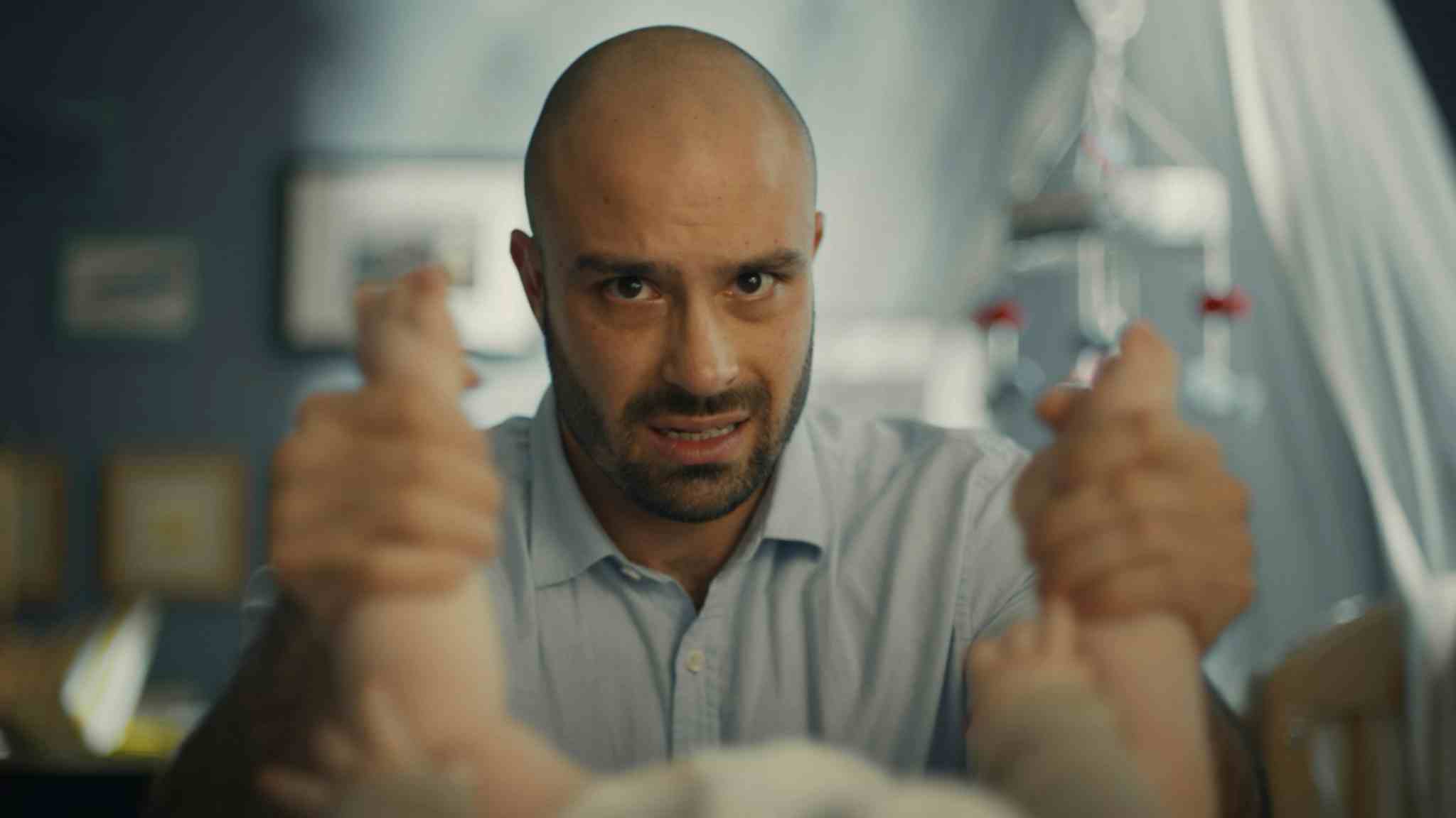 Man holding a baby's ankles