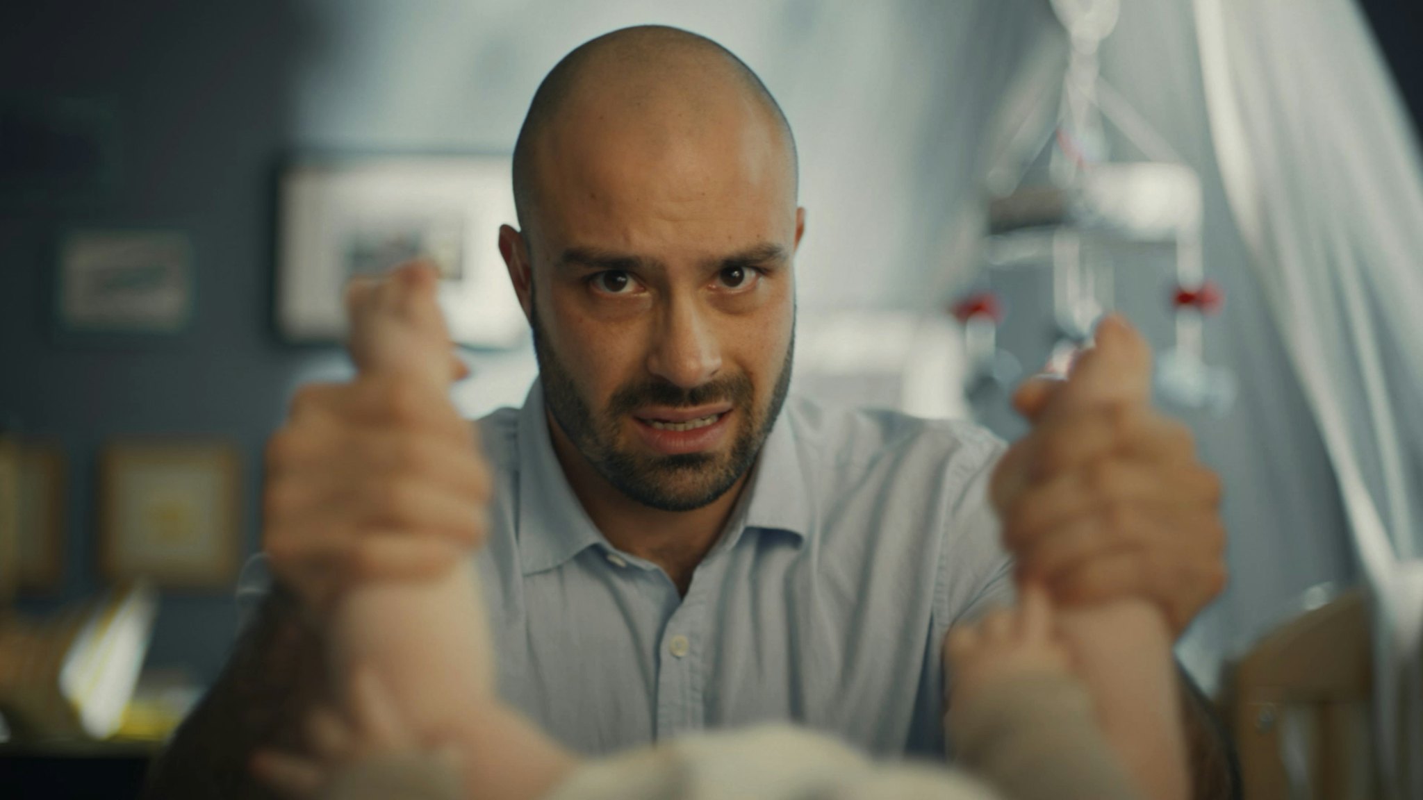 Man holding a baby's ankles