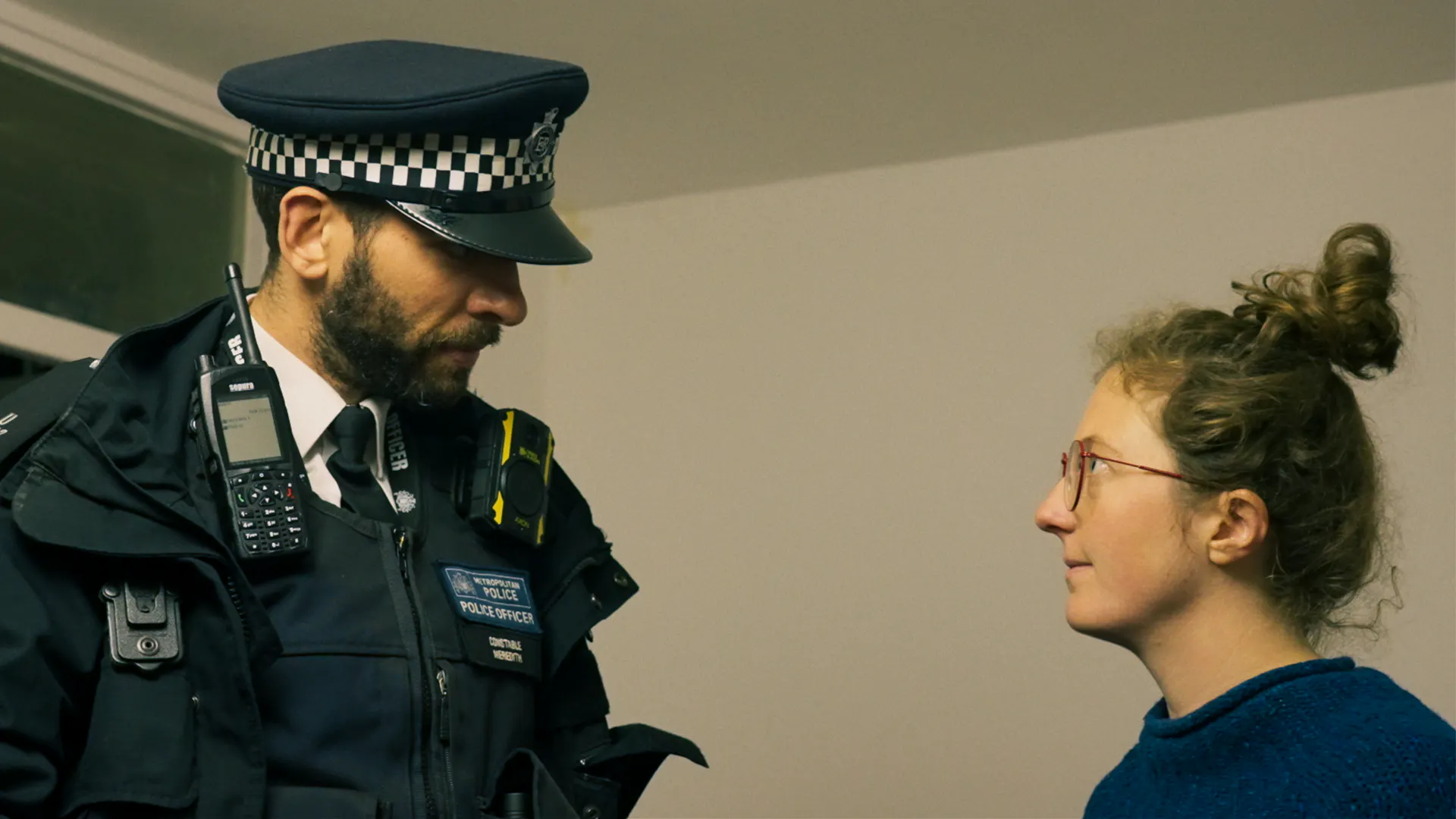 Police looks down at a woman