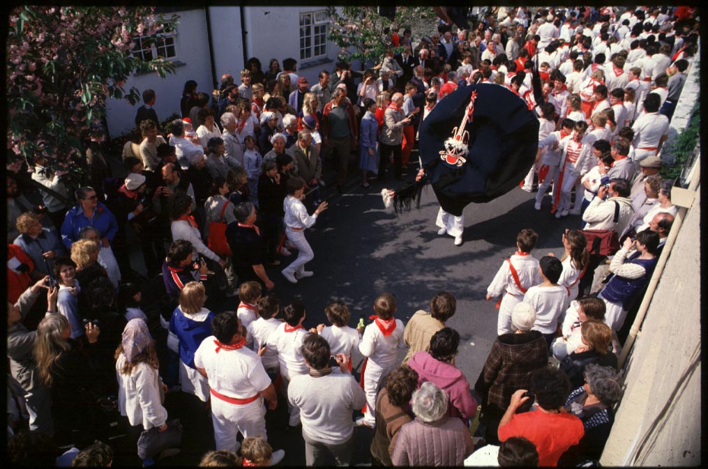 a folk procession with morris dancers and fantastical costume
