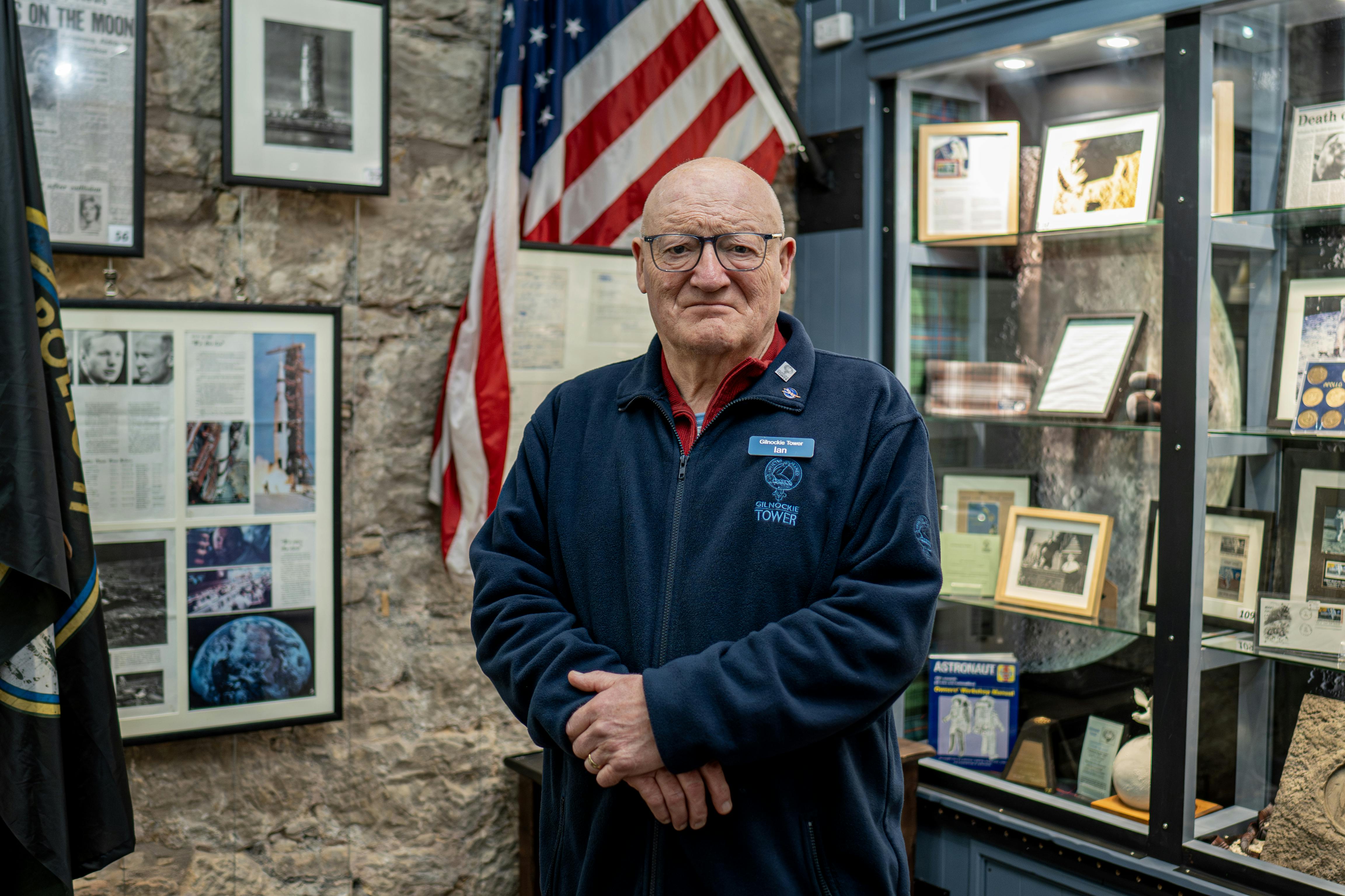 A man in museum with moon landing artefacts looks to camera
