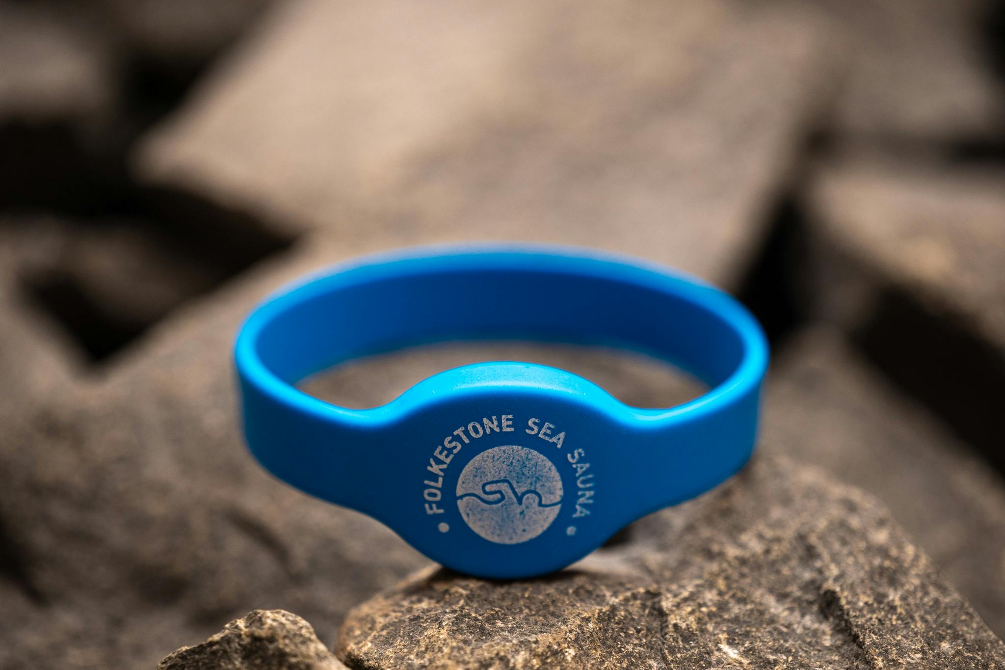 Folkestone Sea Sauna wristband on sauna coals
