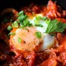Close up of an egg in a pan of shakshouka
